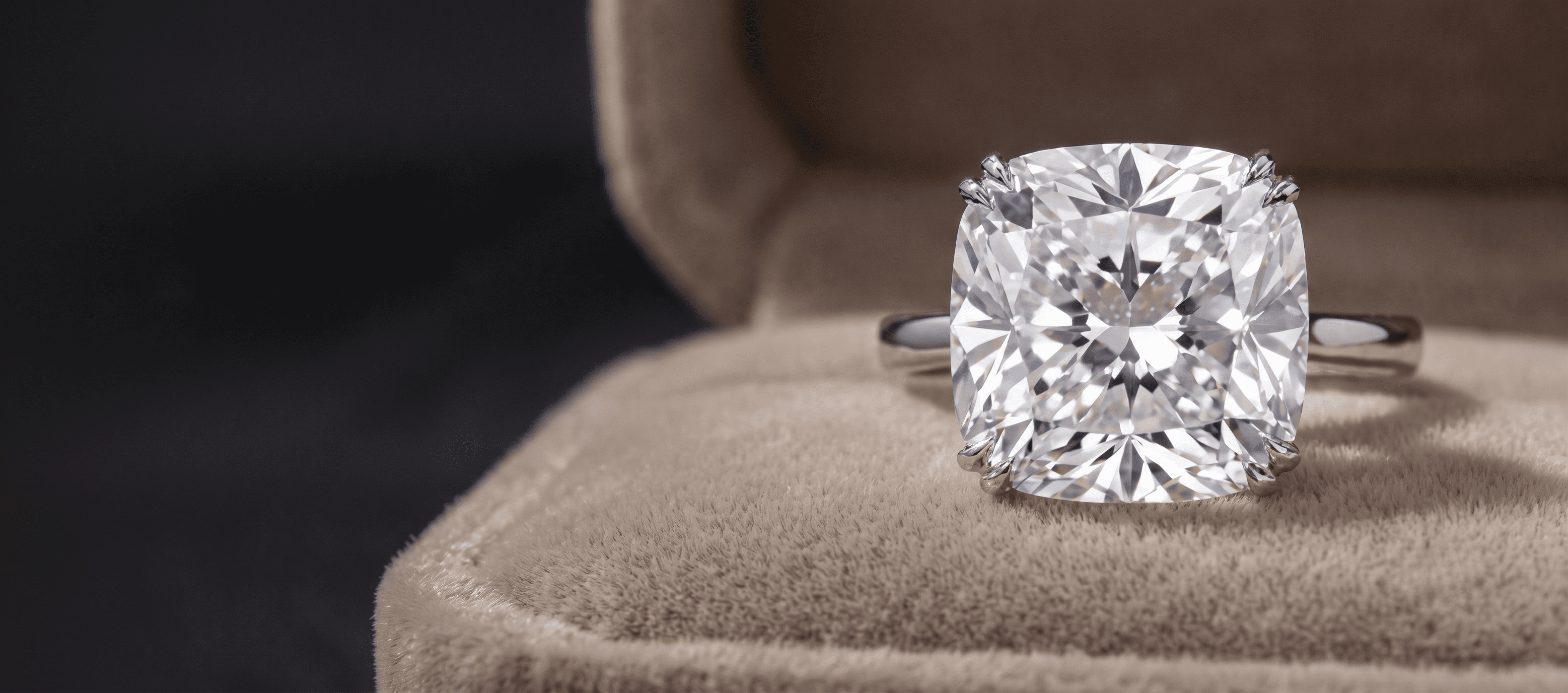 A brilliant-cut diamond, high-key on a pale ground